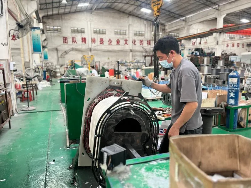 Worker assembling transformer winding in production workshop